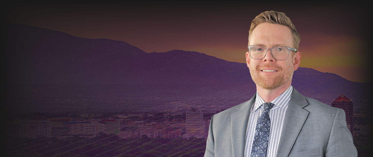 Picture of Matthew J. Bouillon Mascareñas confidently in front of a modern city skyline